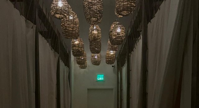 The candlelit hallway inside The NOW Massage