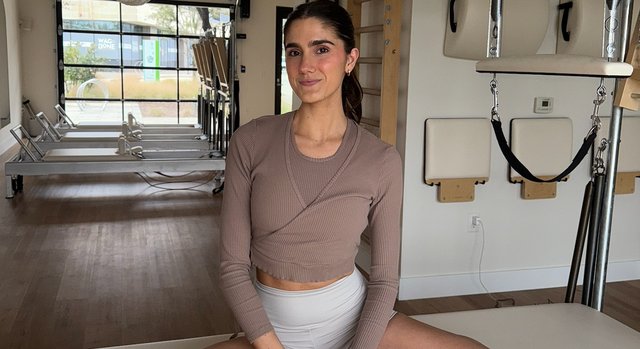 Isabella on a reformer at Pilates Society