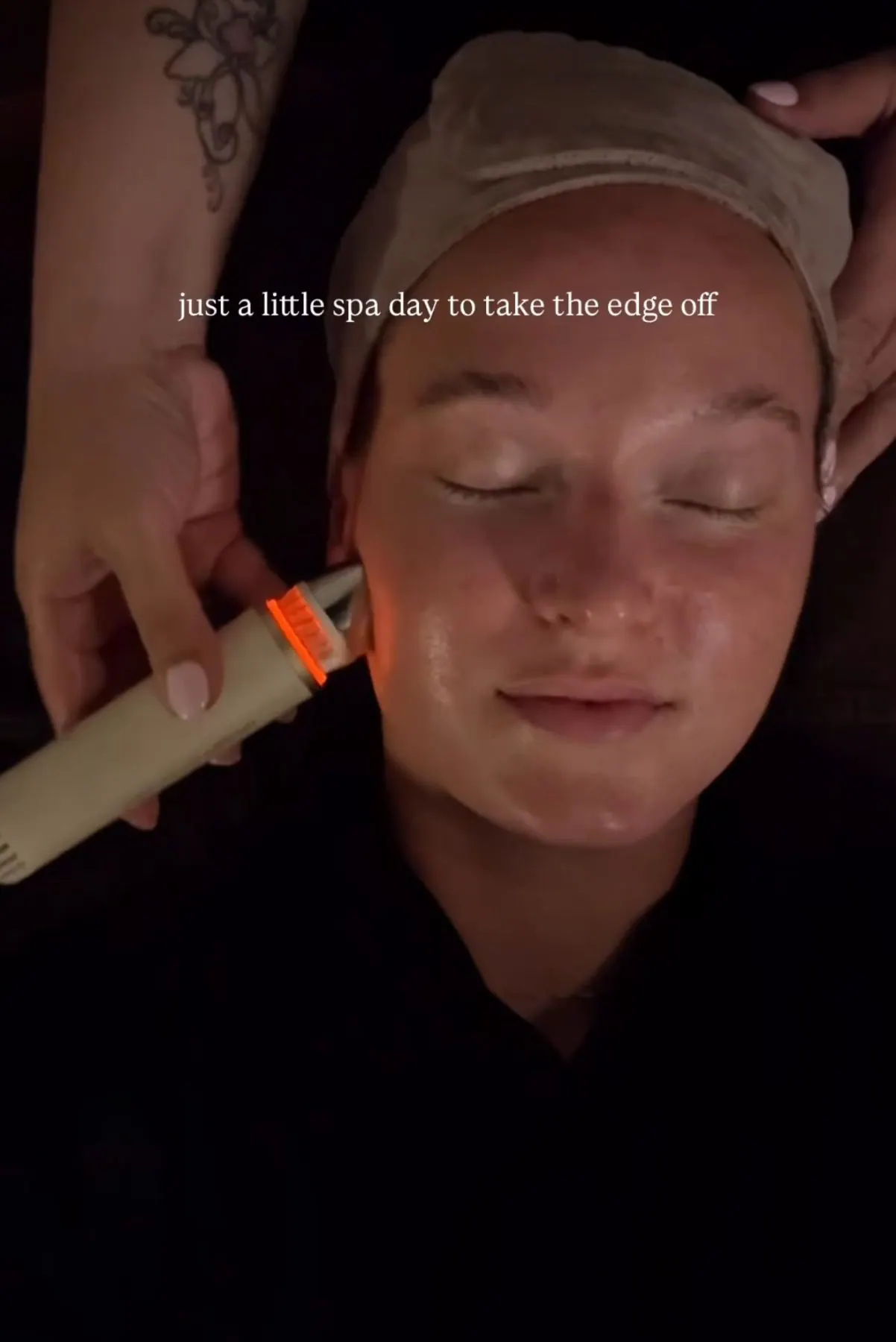 Creator relaxing during a facial with a handheld device, captioned just a little spa day