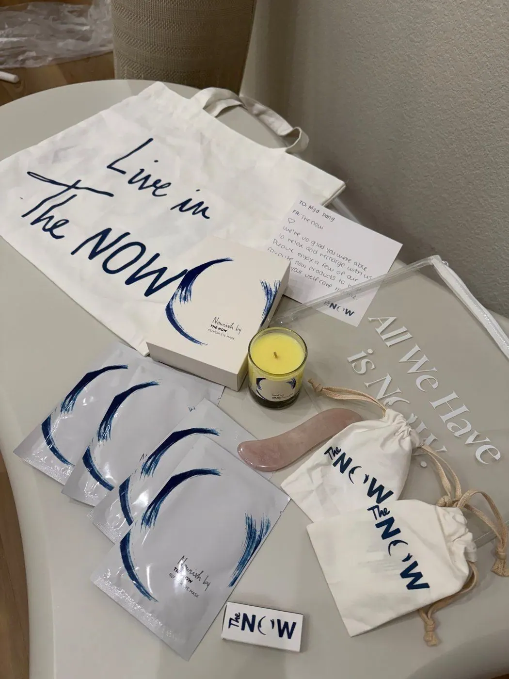 The NOW Massage gift set with a tote, eye masks, a candle and a handwritten note